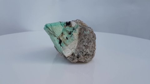 Amazonite is a color variety of Microcline and a Potassium rich member of Feldspar mineral group.  This particular specimen has Smoky Quartz, Mica and Garnet on surface, locality, Pakistan.