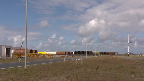 storage of large monopiles, steel foundations for offshore wind farms, on a quay in Rotterdam Seaport Maasvlakte 2