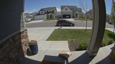 Security camera footage of man stealing package from front stoop / Lehi, Utah, United States