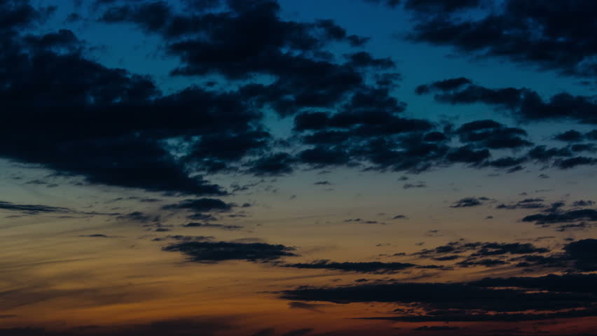 Bright summer night.. 4K beautiful dark cloudy sky before sunrise, time-lapse from dark to light the sky. A gradient in color from orange to dark blue Royalty-Free Stock Footage #10365800