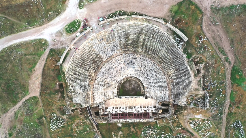 Pamukkale / Turkey - July 17 2019: Amphitheater of the ancient city of Hierapolis. Video shooting from the air.