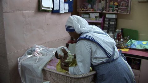 Kolkata / India - 08 14 2019: Nun Caring And Cradling Malnourished Infant At Orphanage In Kolkata