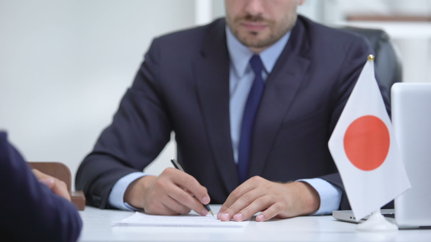 Japanese diplomat signing document of national importance, business cooperation