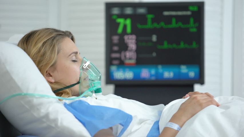 Stabilized woman in oxygen mask sleeping, intensive care hospital unit, surgery Royalty-Free Stock Footage #1036589864