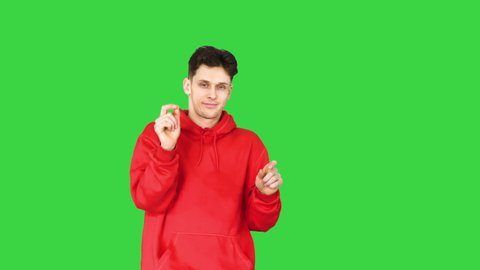 Casual man in red hoody dancing on a Green Screen, Chroma Key.