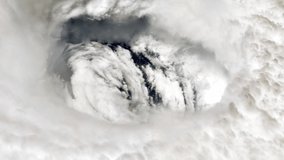 Plane flying Over the Eye of a Hurricane, as Seen from Above. Elements of this Video furnished by NASA.