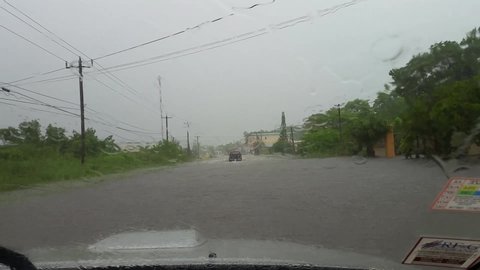 Belize City / Belize -  October 18, 2015: Heavy rains have caused much of Belize City to flood.  Shot from the POV of a truck driving through the flooded street.