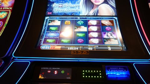 COQUITLAM , British Columbia / Canada - 01 05 2016: Coquitlam, BC, Canada - January 05, 2016 : Close up man playing slot machine inside Hard Rock Casino with 4k resolution