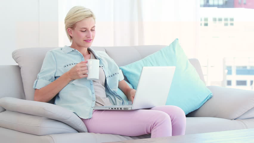 Pretty blond woman using computer in the living room | Shutterstock HD Video #10366106