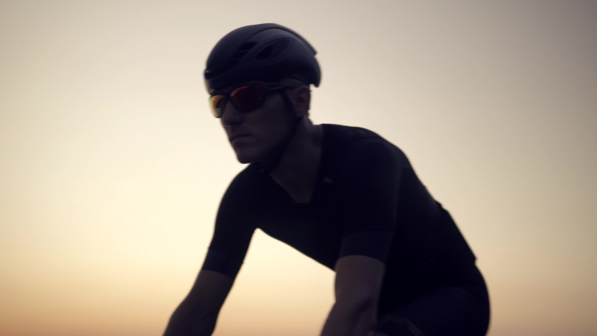 Cyclist Rider In Helmet And Sportswear Riding Workout At Sunset On Triathlon Time Trial Bicycle.Cyclist Professional Fit Man On Triathlon Bicycle.Triathlete Training On Bike.Cycling Exercise On Bike. | Shutterstock HD Video #1036611035