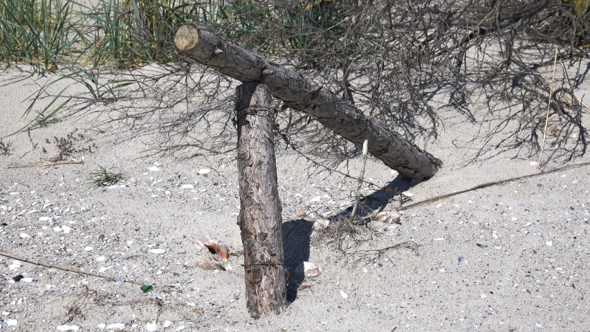 Broken barbed wire fence in the sand