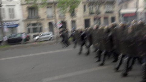 Paris / France - 05 01 2017: Riot police with shields charge towards protestors