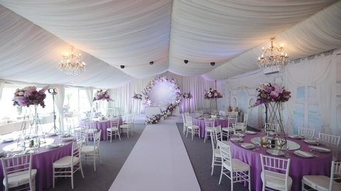 wonderful wedding hall with purple white decoration and close view on modern black microphone slow motion