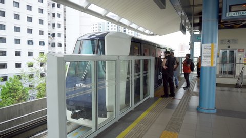 Small Automated Train Arriving at LRT Station in Singapore - August, 2019