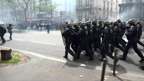 Paris / France - 05 01 2017: Riot police with shields march towards protestors