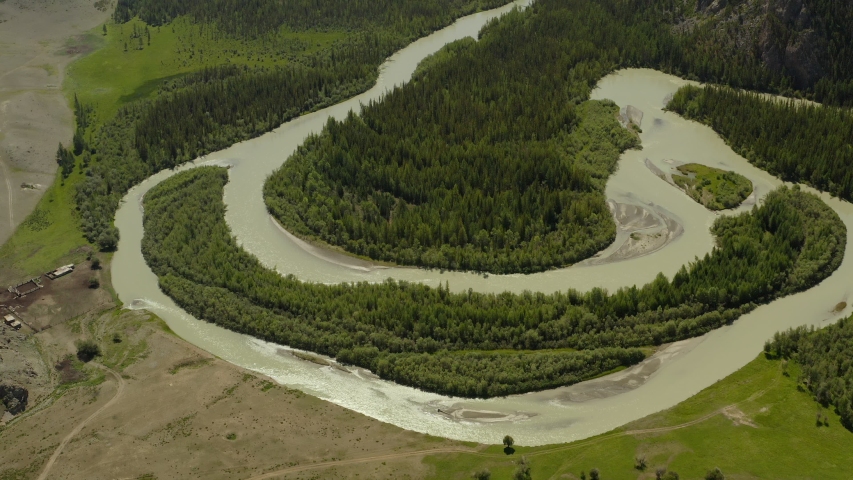 Beautiful spring landscape with mountains, forest and river. Aerial View. Drone shot over a beautiful mountain forest river