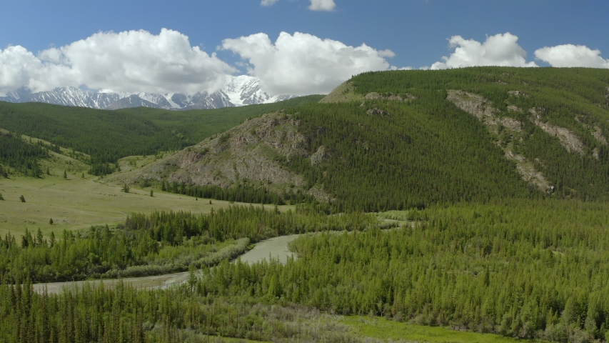 Beautiful spring landscape with mountains, forest and river. Aerial View. Drone shot over a beautiful mountain forest river