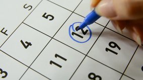 Blue circle mark on the number 12 in the calendar, close-up - Powered by Shutterstock - Get 15% off with code: PIKWIZARD15