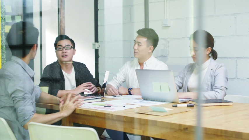group of young asian entrepreneurs discussing business in company meeting room Royalty-Free Stock Footage #1036633289