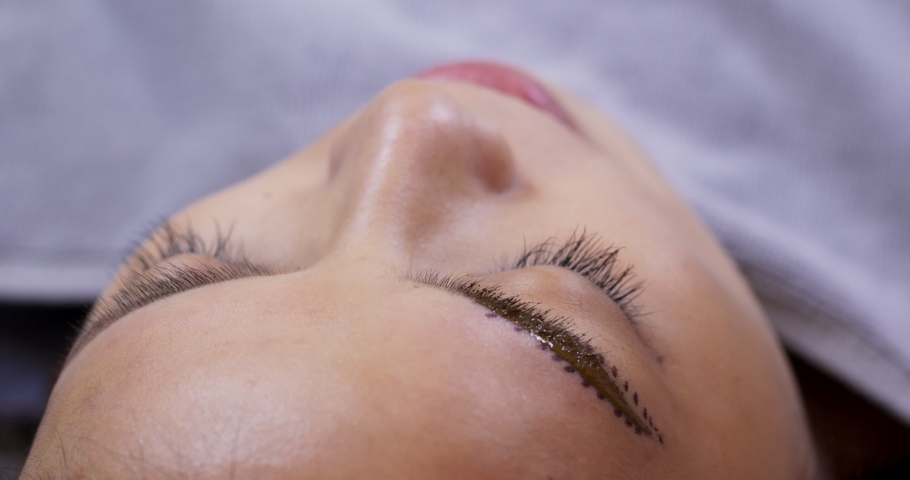 Beautician specialist of permanent makeup making brow microblading tattooing make up