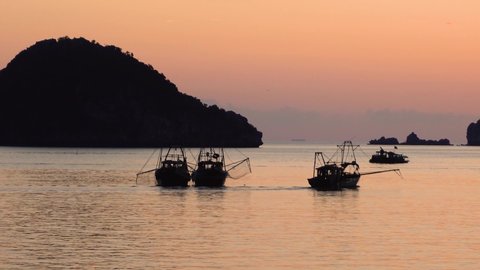 Sunset on beach in Ha Long Bay, Cat Ba island, fishing boats. Asia
