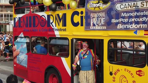 BENIDORM:SPAIN:07/09/2019 
GAY PRIDE -OLD MAN STANDING IN THE TOURIST BUS  SMILING TO CROWD