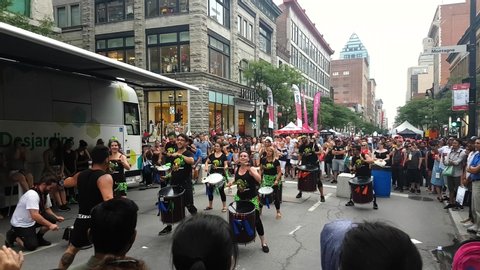 Montreal / Canada - 07 06 2019: Crazy band playing drums in a lively performance in public