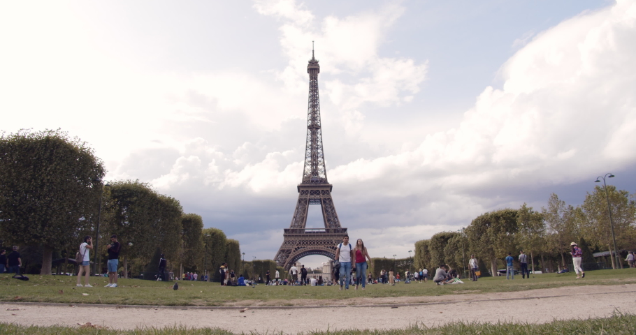 Paris / France - 08 14 2019: Timelapse: View of the Eiffel Tower from Champ de Mars on a cloudy Summer Day | Shutterstock HD Video #1036656014