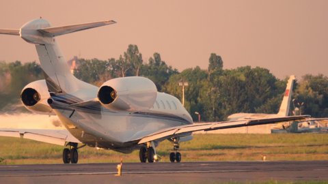 Business jet (private jet) taking off at sunset