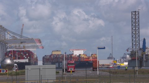 ROTTERDAM SEAPORT - 3 SEPTEMBER 2019: worlds largest container ship MSC Gulsun calling on the APMT2 terminal at Maasvlakte 2 in Rotterdam Seaport. Heavy traffic container lorries on the quay