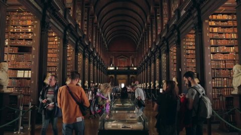 Dublin / Ireland - 08 06 2019: People walking around in the Long Room in Trinity College Library, Dublin, Ireland, on August 6, 2019