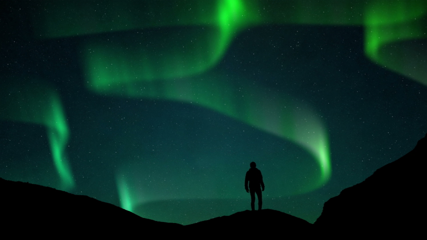 Aurora Borealis Green fluor Northern Lights and silhouette man watching. Winter landscape with polar weather in Arctic, Norway,Canada,Finland,Iceland, Sweden. Starry night sky scenery background 4k Royalty-Free Stock Footage #1036677812