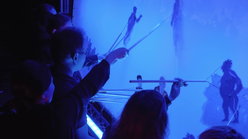 teamwork of a group of actors playing in the shadow theater