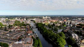 Aerial footage of the town of York located in North East England and founded by the ancient Romans, the footage shows the York Minster Historical Cathedral in the main town centre along the river.