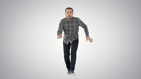 Young crazy man dancing and wanking forward on gradient background.