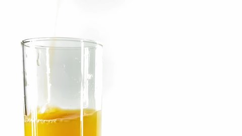 Orange Juice being Poured A Tall  Glass Against White Background. Concept Of: Diet, Healthy Drinks Vitamins, Vegetarian