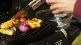 Vegeterain Barbecue on a sunny day in the garden. Colourful vegetables grilled on a BBQ. 4k videos. Close up on healthy meal