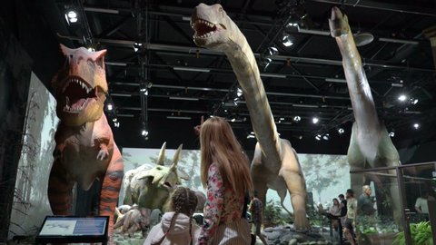 VANTAA, FINLAND - JUNE 10,2019: Children and adults see interactive models of dinosaurs. Children's educational entertainment science Museum Eureka (Heureka)