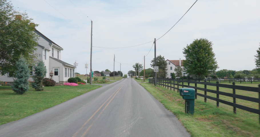 Drive Through Scenic Rural Farmland with Barn and Silos