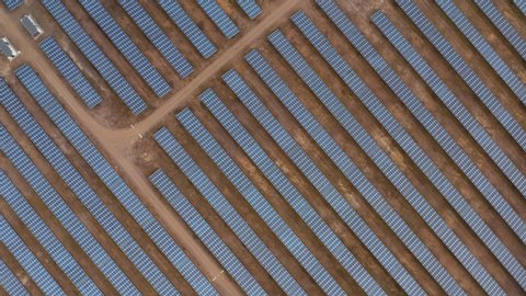 Solar panels in a large cluster forming solar power plant, top down view