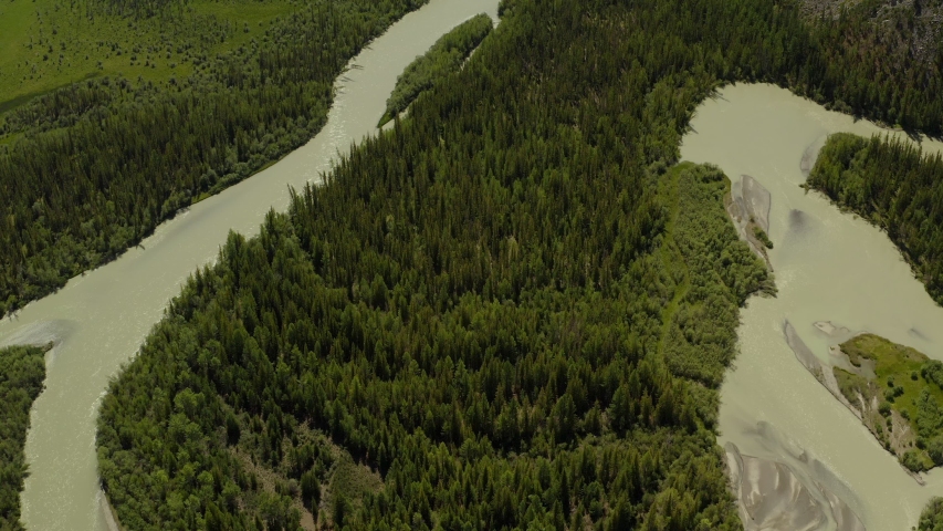 Beautiful spring landscape with mountains, forest and river. Aerial View. Drone shot over a beautiful mountain forest river