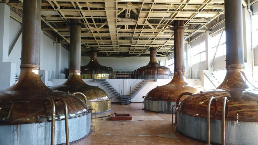 Brewery. The premises of the old brewery where boilers are installed in which the beer must is brewed. The movement of the camera from above along the entire room. | Shutterstock HD Video #1036723727