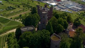 Aerial view of the village and castle palace Ortenberg in Germany  on a sunny day in summer. Pan to the left beside the castle.
