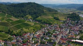 Aerial view of the village and castle palace Ortenberg in Germany  on a sunny day in summer. Flying over the village.
