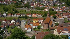 Aerial view of the city Weisenbach in Germany on a sunny day in summer. Ascending from the hills beside the city.