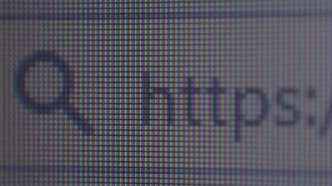 Extreme macro of a laptop screen with https website in the browser. Secure internet surfing concept.