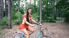 Women's bike. A woman is standing with a female bike in the forest.