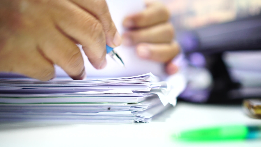 Businessman hands working in stacks of paper files for searching information on work desk office, business report papers,piles of unfinished documents achieves with clips indoor,Business concept | Shutterstock HD Video #1036734701