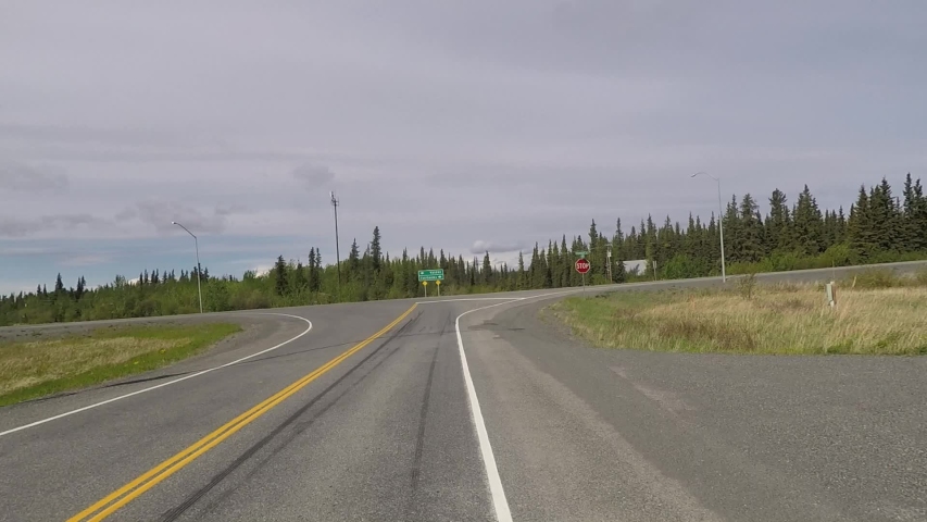 POV of driver approaching highway junction and turning. Fairbanks Valdez sign. Richardson Highway.