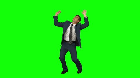 Businessman standing and cowering on green screen background